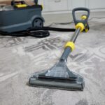 Professional,Cleaning,Vacuum,Cleaner,In,Action,On,A,Gray,Living