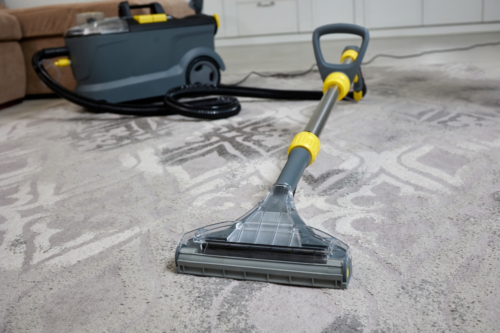 Professional,Cleaning,Vacuum,Cleaner,In,Action,On,A,Gray,Living